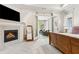 Main bedroom with fireplace, television, and private balcony at 1227 Magnolia Path Way, Sugar Hill, GA 30518