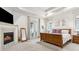 Main bedroom suite with fireplace, TV, and balcony access at 1227 Magnolia Path Way, Sugar Hill, GA 30518