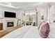 Spacious main bedroom featuring a fireplace, television, and access to an outdoor sitting area at 1227 Magnolia Path Way, Sugar Hill, GA 30518