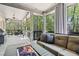 Relaxing screened patio featuring a fire pit, seating area, ceiling fan and wooded views at 1227 Magnolia Path Way, Sugar Hill, GA 30518