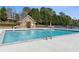 Community pool with clear blue water and ample deck space for lounging in the sun at 1227 Magnolia Path Way, Sugar Hill, GA 30518