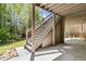 Outdoor staircase leading to upper level with views of the spacious backyard and greenery at 1227 Magnolia Path Way, Sugar Hill, GA 30518