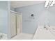 Bright bathroom featuring a glass-enclosed shower and a white vanity with a sleek countertop at 1315 Pembridge Nw Way, Kennesaw, GA 30152