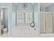 Bathroom featuring jetted tub, shower stall, and shuttered windows at 1315 Pembridge Nw Way, Kennesaw, GA 30152