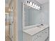 Bathroom featuring a large mirror with vanity lights, a white vanity, and neutral walls at 1315 Pembridge Nw Way, Kennesaw, GA 30152