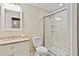 Well-lit bathroom with modern vanity, granite countertop, and walk-in shower with sliding glass doors at 1315 Pembridge Nw Way, Kennesaw, GA 30152