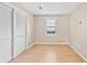 Bedroom featuring hardwood floors, neutral walls, shuttered windows, and a closet with sliding doors at 1315 Pembridge Nw Way, Kennesaw, GA 30152