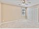 Neutral bedroom featuring carpeted floors, a ceiling fan, a window with shutters, and double closet doors at 1315 Pembridge Nw Way, Kennesaw, GA 30152