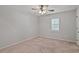 Spacious bedroom featuring carpeted floors, a ceiling fan, a window with shutters, and neutral walls at 1315 Pembridge Nw Way, Kennesaw, GA 30152