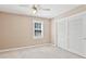 Bedroom featuring carpeted floors, neutral walls, a ceiling fan and a closet with sliding doors at 1315 Pembridge Nw Way, Kennesaw, GA 30152