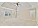 Spacious bedroom with tray ceilings, carpeting, and natural light from many windows at 1315 Pembridge Nw Way, Kennesaw, GA 30152