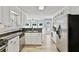 Well lit kitchen featuring white cabinets, stainless steel appliances, and stone countertops at 1315 Pembridge Nw Way, Kennesaw, GA 30152