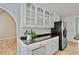 Kitchen area with stone countertops, white cabinets and stainless steel refrigerator at 1315 Pembridge Nw Way, Kennesaw, GA 30152