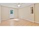 The room has a modern ceiling fan, hardwood floors, a door to the outside, and an eye-catching wine rack at 1315 Pembridge Nw Way, Kennesaw, GA 30152