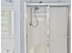 Modern shower with a sliding glass door, integrated seating, and a contemporary shower head at 1315 Pembridge Nw Way, Kennesaw, GA 30152