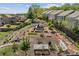Aerial view of the community backyard showcasing garden beds, a fish pond, and landscaping at 4241 Woodward Walk Ln, Suwanee, GA 30024