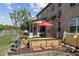 Backyard with a lush lawn, patio area with outdoor furniture, and raised garden beds perfect for gardening and entertaining at 4241 Woodward Walk Ln, Suwanee, GA 30024