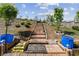 Backyard with a garden path and raised garden beds leads to a lush backyard with landscaping at 4241 Woodward Walk Ln, Suwanee, GA 30024