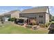 Spacious backyard featuring a screened porch, deck, garden, and well-manicured lawn at 4241 Woodward Walk Ln, Suwanee, GA 30024