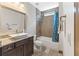 This bathroom offers granite counters, tile flooring, and a tub/shower combo at 4241 Woodward Walk Ln, Suwanee, GA 30024