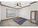 This bedroom features neutral carpeting and a window with blinds at 4241 Woodward Walk Ln, Suwanee, GA 30024