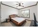 This bedroom features a leather bed frame and a ceiling fan at 4241 Woodward Walk Ln, Suwanee, GA 30024