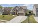Charming brick home with well-maintained lawn, mature trees, and spacious driveway at 4241 Woodward Walk Ln, Suwanee, GA 30024