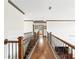 This hallway features hardwood floors and ornamental iron railing at 4241 Woodward Walk Ln, Suwanee, GA 30024