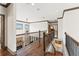This hallway features hardwood floors and ornamental iron railing at 4241 Woodward Walk Ln, Suwanee, GA 30024
