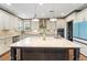 Bright eat-in kitchen with center island, stainless appliances and custom cabinetry at 4241 Woodward Walk Ln, Suwanee, GA 30024