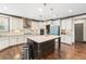 Spacious kitchen featuring a center island, pendant lighting, and modern appliances at 4241 Woodward Walk Ln, Suwanee, GA 30024