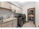 This laundry room features built-in cabinets and a newer washer and dryer at 4241 Woodward Walk Ln, Suwanee, GA 30024
