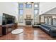 Inviting living room with stone fireplace, hardwood floors, and soaring ceilings at 4241 Woodward Walk Ln, Suwanee, GA 30024