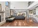 Spacious living area featuring hardwood floors, stone fireplace, and open floor plan at 4241 Woodward Walk Ln, Suwanee, GA 30024