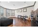Cozy living room featuring hardwood floors, natural light, and versatile layout at 4241 Woodward Walk Ln, Suwanee, GA 30024