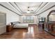 The main bedroom has a tray ceiling, ceiling fan, and hardwood flooring at 4241 Woodward Walk Ln, Suwanee, GA 30024