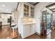 Butler's pantry boasts beautiful cabinetry, granite countertops, and ample storage at 4241 Woodward Walk Ln, Suwanee, GA 30024