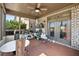 A screened porch features a ceiling fan and provides access to the backyard through glass paneled double doors at 4241 Woodward Walk Ln, Suwanee, GA 30024