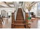Open staircase with hardwood steps and iron balusters leading to the second level at 4241 Woodward Walk Ln, Suwanee, GA 30024