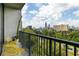 Inviting balcony with yellow seating overlooking a vibrant cityscape and green tree landscape at 480 John Wesley Dobbs Ne Ave # 716, Atlanta, GA 30312