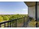 Charming balcony with metal railing showcasing scenic green tree views and yellow patio furniture at 480 John Wesley Dobbs Ne Ave # 716, Atlanta, GA 30312