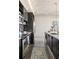 Galley kitchen with modern appliances, sleek cabinets, and unique backsplash tiles at 480 John Wesley Dobbs Ne Ave # 716, Atlanta, GA 30312