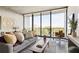 Cozy living room with large windows, city view, comfortable seating, and stylish decor at 480 John Wesley Dobbs Ne Ave # 716, Atlanta, GA 30312