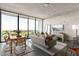Bright living room with large windows, city views, modern furnishings, and stylish decor at 480 John Wesley Dobbs Ne Ave # 716, Atlanta, GA 30312