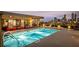 Lit rooftop pool with stairs overlooking the city skyline, with lounge area at 480 John Wesley Dobbs Ne Ave # 716, Atlanta, GA 30312