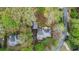 Aerial view showcases a home with lush landscaping and mature trees at 6450 Oak Valley Dr, Cumming, GA 30040