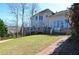 The backyard features a well-manicured lawn with a brick path at 6450 Oak Valley Dr, Cumming, GA 30040