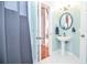 Charming bathroom with pedestal sink, tile floors, and a view into the home's entryway at 6450 Oak Valley Dr, Cumming, GA 30040