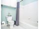 Cozy bathroom featuring a bathtub, toilet and gray shower curtain at 6450 Oak Valley Dr, Cumming, GA 30040