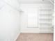 Walk-in closet with multiple shelves, carpet and a window with shutter blinds at 6450 Oak Valley Dr, Cumming, GA 30040